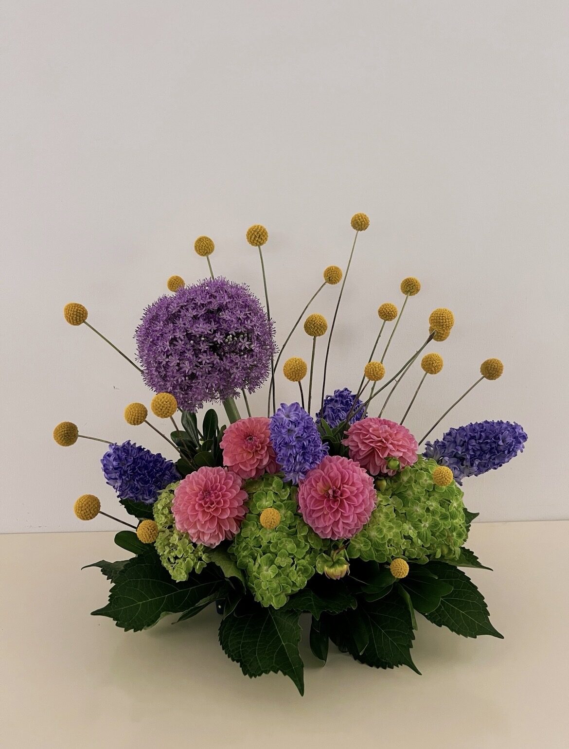 Purple allium, pink dahlias, hyacinth and craspedia arrangement