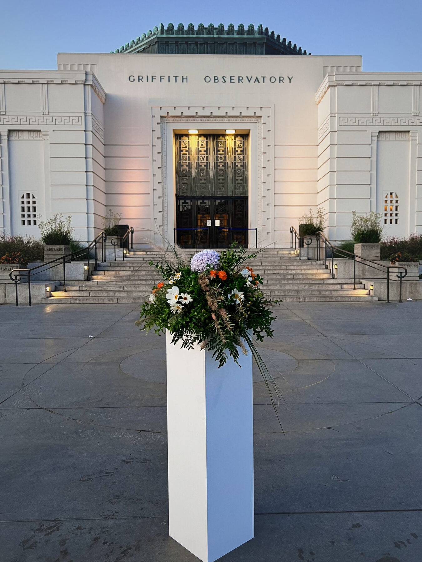 Wildflower and allium pillar arrangement in front of Griffith Observatory